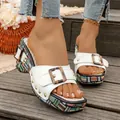 Close-up of stylish white platform sandals featuring a chic buckle and vibrant woven sole design - 35 / White