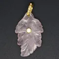 Close-up view of a natural rose quartz leaf pendant featuring a gold-toned bail and inset zircon - Rose Quartz