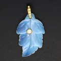 Macro shot of a carved light blue Amazonite leaf pendant with sparkling zircon detail - Opal