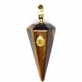 Macro view of hexagonal Tiger's Eye stone pendant with embedded yellow teardrop gem - Tiger's Eye