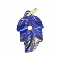 Close-up of a leaf-shaped lapis lazuli pendant with a gold-toned bail and inlaid zircon. - Lapis Lazuli