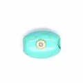 Close-up of turquoise barrel bead jewelry part with centered zircon stone in gold bezel - Turquoise