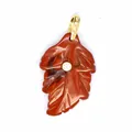 Detailed close-up shot of a red stone leaf pendant featuring a brilliant central zircon inlay. - Red Jasper