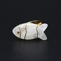 Macro view of handmade wire wrapped fish ring featuring carved natural white stone. - Fish Shaped Carving (aljylr2064) / White Crystal