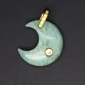 Close-up of a green natural stone moon pendant with gold bail and zircon inlays. - Amazonite