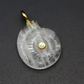 Detailed view of hand-carved crystal nautilus shell pendant with gold bail and zircon. - White Crystal