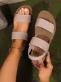 Close-up detail of stylish beige flat sandals featuring textured elastic straps for comfort - 36 / Off White