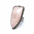 Macro detail view of a vintage shield-shaped ring with faceted pink natural stone - Rose Quartz