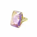 Detailed close-up of a large rectangular purple and yellow natural stone ring in gold - Amethyst