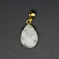 Close-up of a faceted teardrop natural stone pendant featuring a gold-plated bail - White Crystal