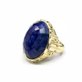 Close-up of ornate gold ring featuring a large faceted oval lapis lazuli stone. - Lapis Lazuli