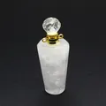 Macro view of natural white crystal perfume bottle pendant with faceted crystal cap and gold ring. - White Crystal / Gold