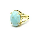 Detailed close-up of a vintage gold ring featuring a faceted oval blue stone - Turquoise