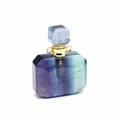 Detailed macro shot of a rainbow fluorite essential oil bottle pendant in briefcase shape - Colorful Fluorite (Gold Finish)