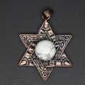 Close-up detail of a vintage copper hexagram pendant with a white natural stone center. - Howlite