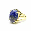 Close-up detail of 13x18mm oval faceted natural stone set in vintage gold ring band - Lapis Lazuli