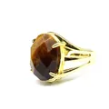 Detailed view of a vintage gold-plated ring with a large oval faceted brown tiger's eye stone. - Tiger's Eye