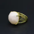 Detailed macro view of a faceted rose quartz stone in a gold-plated claw setting ring. - Rose Quartz