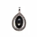 Detailed view of teardrop pendant with black oval stone and engraved silver frame. - Obsidian