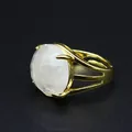 Macro view of a gold-plated ring featuring a large faceted white crystal stone - White Crystal