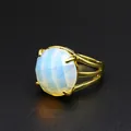 Macro detail of faceted milky opal stone set in a gold-plated open ring band - Opal