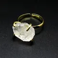 Macro view of a raw clear crystal stone set in a gold-plated adjustable claw ring - White Crystal