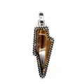 Macro detail of a retro lightning bolt pendant featuring a natural tiger eye stone inlay. - Tiger's Eye