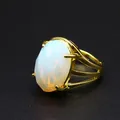 Macro detail of a vintage gold ring with a faceted 13x18mm oval white natural stone. - Opal