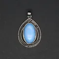 Detail showing the intricate silver texture and blue stone of the teardrop pendant. - Opal