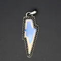 Detailed macro view showing the textured metal frame and white crystal of the lightning bolt pendant - Opal