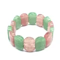 Close-up detail of polished oval green and pink natural stone beads on a stretch bracelet - Hand Plate Style / 11x18mm / Strawberry Quartz