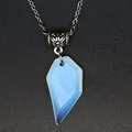 Detailed close-up of a faceted blue and white marbled heart fragment stone pendant - Opal