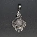 Close-up of a vintage silver-colored foxtail pendant with an oval translucent stone inlay - Rose Quartz