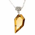 Detailed macro view of a natural tiger's eye stone pendant on a silver necklace chain - Tiger's Eye