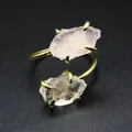 Macro view of raw rose quartz stones on a gold adjustable open ring - Rose Quartz