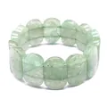 Detailed macro view of natural green stone oval bead bracelet with smooth polished finish - Hand Plate Style / 11x18mm / Green Strawberry Quartz