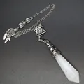 Detail of crystal pendulum pendant with star and dreamcatcher charms on silver chain. - White Crystal