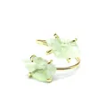 Detailed macro view of natural green raw stone ring with gold four-prong setting - Green Fluorite