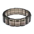 Detail shot showing the texture of dark striped Saffordite tektite stone bracelet. - Polished Style (Dark Brown)
