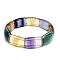 Macro view of a natural rainbow fluorite rectangular stone slab bracelet with colorful bands. - Colorful Fluorite