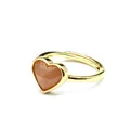 Detailed macro shot of a faceted heart-shaped natural stone set in a gold open ring - Sunstone