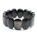 Detailed macro view of polished oval blue tiger eye stone beads on a stretch bracelet - Hand Plate Style / 11x18mm / Blue Tiger Eye Stone