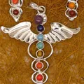 Detailed macro shot of silver caduceus pendant featuring seven colorful chakra gemstones - Caduceus Style (6)