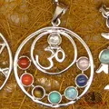 Detail of silver chakra pendant necklace featuring a central Om symbol and seven gemstones. - Om Symbol Design (10)