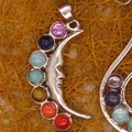 Close-up of crescent moon chakra pendant with colorful gemstones - Moon Face Style (11)