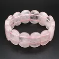 Detailed macro view of smooth pink rose quartz oval beads on a flexible stretch bracelet - Hand Plate Style / 11x18mm / Rose Quartz