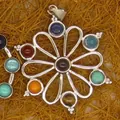 Close-up of a silver-toned flower pendant featuring various multi-colored gemstones. - Hollow Flower Style (12)