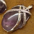 Natural oval amethyst crystal pendant with silver crisscross cage and sparkling accents - Purple Amethyst Pendant