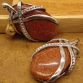 Oval shaped brown sparkling goldstone pendant necklace with silver-plated wire wrap detail - Goldstone Pendant