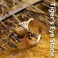 Handmade rose gold wire wrapped ring featuring a polished natural tiger's eye stone bead - One Size / Tiger's Eye